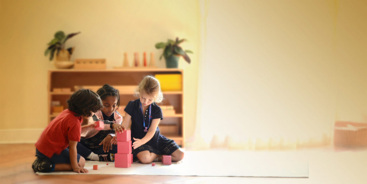 Children using building bricks at La Prima Casa Montessori school